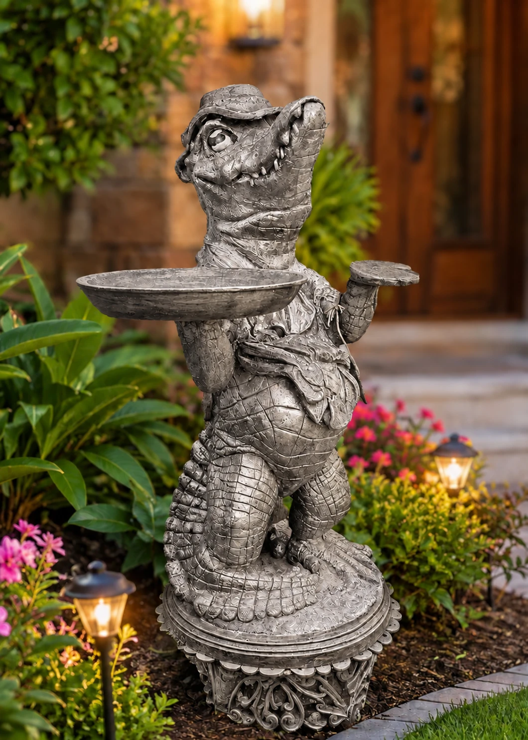 Alligator statue with tray in Silver Patina finish in a landscaped garden