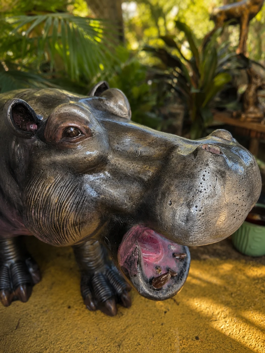 Hand-painted hippo statue garden detail view