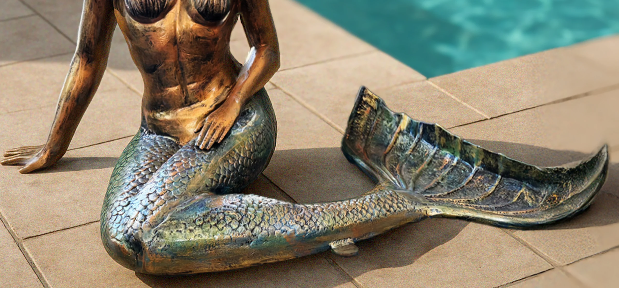 Life size mermaid sculpture in aged copper finish for outdoor poolside display